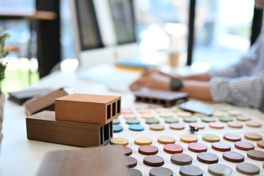 Color swatches and sample of wooden panel for furniture on interior designer working desk