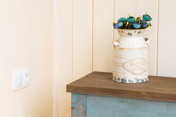 a vase with flowers is sitting on a table in a room
