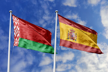 3d illustration. Belarus and Spain Flag waving in sky. High detailed waving flag. 3D render. Waving in sky. Flags fluttered in the cloudy sky.