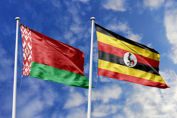 3d illustration. Belarus and Uganda Flag waving in sky. High detailed waving flag. 3D render. Waving in sky. Flags fluttered in the cloudy sky.