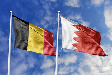 3d illustration. Belgium and Bahrain Flag waving in sky. High detailed waving flag. 3D render. Waving in sky. Flags fluttered in the cloudy sky.