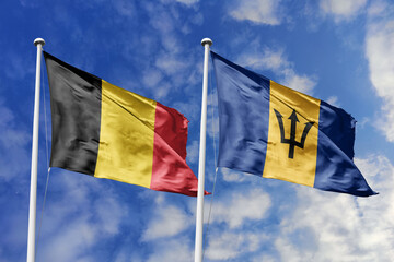 3d illustration. Belgium and Barbados Flag waving in sky. High detailed waving flag. 3D render. Waving in sky. Flags fluttered in the cloudy sky.