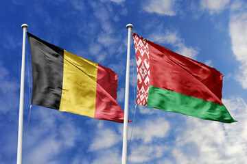 3d illustration. Belgium and Belarus Flag waving in sky. High detailed waving flag. 3D render. Waving in sky. Flags fluttered in the cloudy sky.
