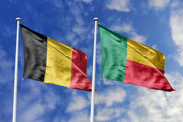 3d illustration. Belgium and Benin Flag waving in sky. High detailed waving flag. 3D render. Waving in sky. Flags fluttered in the cloudy sky.