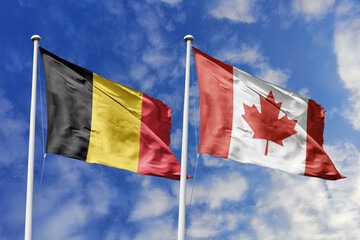 3d illustration. Belgium and Canada Flag waving in sky. High detailed waving flag. 3D render. Waving in sky. Flags fluttered in the cloudy sky.