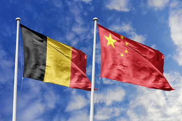 3d illustration. Belgium and China Flag waving in sky. High detailed waving flag. 3D render. Waving in sky. Flags fluttered in the cloudy sky.