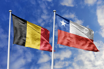 3d illustration. Belgium and Chile Flag waving in sky. High detailed waving flag. 3D render. Waving in sky. Flags fluttered in the cloudy sky.