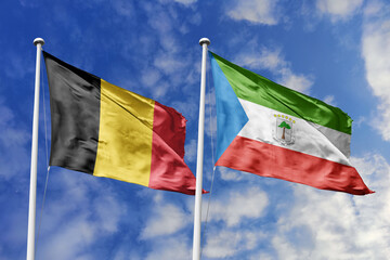 3d illustration. Belgium and Equatorial Guinea Flag waving in sky. High detailed waving flag. 3D render. Waving in sky. Flags fluttered in the cloudy sky.