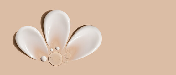 composition of brush strokes of creamy texture of cosmetic samples on a pastel beige background