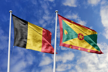 3d illustration. Belgium and Grenada Flag waving in sky. High detailed waving flag. 3D render. Waving in sky. Flags fluttered in the cloudy sky.