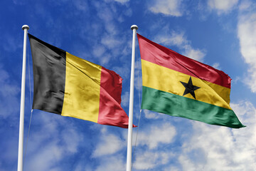 3d illustration. Belgium and Ghana Flag waving in sky. High detailed waving flag. 3D render. Waving in sky. Flags fluttered in the cloudy sky.