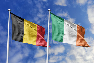 3d illustration. Belgium and Ireland  Flag waving in sky. High detailed waving flag. 3D render. Waving in sky. Flags fluttered in the cloudy sky.