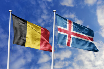 3d illustration. Belgium and Iceland Flag waving in sky. High detailed waving flag. 3D render. Waving in sky. Flags fluttered in the cloudy sky.