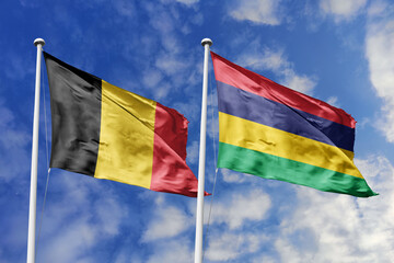 3d illustration. Belgium and Mauritius Flag waving in sky. High detailed waving flag. 3D render. Waving in sky. Flags fluttered in the cloudy sky.