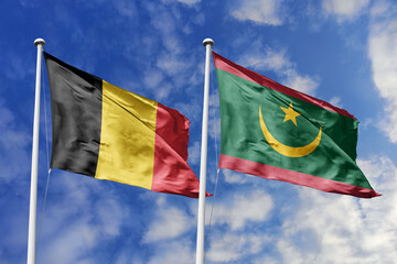 3d illustration. Belgium and Mauritania Flag waving in sky. High detailed waving flag. 3D render. Waving in sky. Flags fluttered in the cloudy sky.