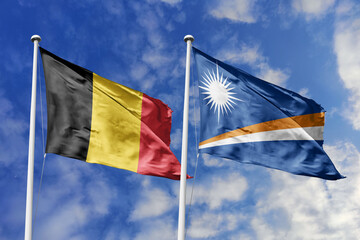 3d illustration. Belgium and Marshall Islands Flag waving in sky. High detailed waving flag. 3D render. Waving in sky. Flags fluttered in the cloudy sky.