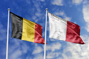 3d illustration. Belgium and Malta Flag waving in sky. High detailed waving flag. 3D render. Waving in sky. Flags fluttered in the cloudy sky.