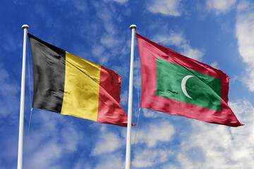 3d illustration. Belgium and Maldives Flag waving in sky. High detailed waving flag. 3D render....