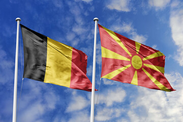 3d illustration. Belgium and  North Macedonia Flag waving in sky. High detailed waving flag. 3D render. Waving in sky. Flags fluttered in the cloudy sky.