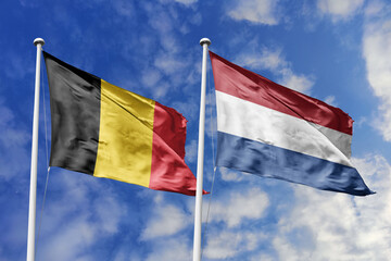 3d illustration. Belgium and Netherlands Flag waving in sky. High detailed waving flag. 3D render. Waving in sky. Flags fluttered in the cloudy sky.
