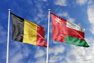 3d illustration. Belgium and Oman Flag waving in sky. High detailed waving flag. 3D render. Waving...