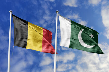 3d illustration. Belgium and Pakistan Flag waving in sky. High detailed waving flag. 3D render. Waving in sky. Flags fluttered in the cloudy sky.