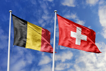 3d illustration. Belgium and Switzerland Flag waving in sky. High detailed waving flag. 3D render. Waving in sky. Flags fluttered in the cloudy sky.