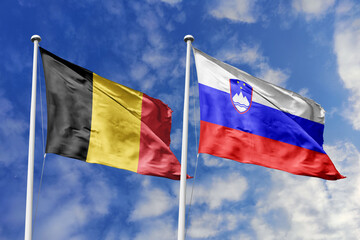 3d illustration. Belgium and Slovenia Flag waving in sky. High detailed waving flag. 3D render. Waving in sky. Flags fluttered in the cloudy sky.