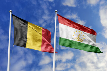 3d illustration. Belgium and Tajikistan Flag waving in sky. High detailed waving flag. 3D render. Waving in sky. Flags fluttered in the cloudy sky.