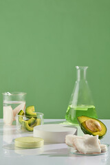 Various types of lab glassware including erlenmeyer of green essence, beakers with transparent...