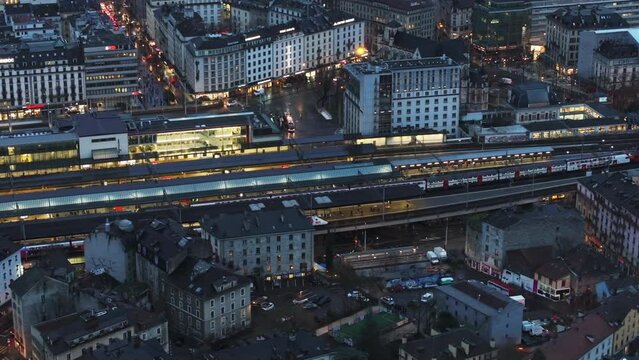 Aerial view of trains arriving at Geneva's station, highlighting its efficient public transportation system
