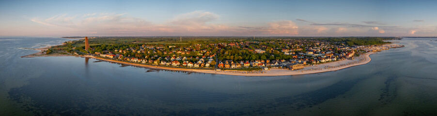 Panoramic view of Baltic Sea resort of Laboe, showcasing promenade, beach dotted with hooded beach...