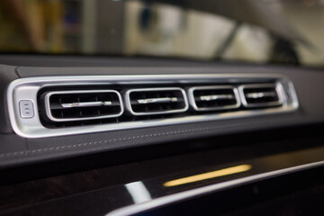 Closeup of car dashboard air vents near gear shift