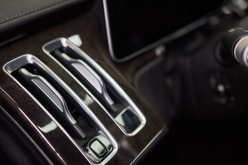Closeup of car dashboard air vents near gear shift