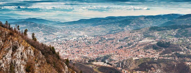 A captivating aerial view of Sarajevo's cityscape nestled amidst the scenic hills of Bosnia and...
