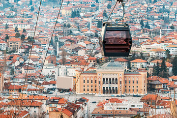 the beauty of Sarajevo's skyline from above as you journey through the cityscape in a cable car, passing over the rooftops and town hall.