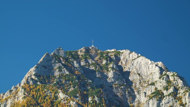 Drone shot of Caraiman Peak with the Heroes Cross against blue sky background in Bucegi Mountains