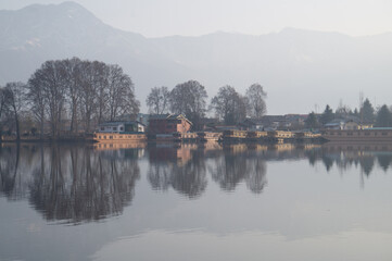 Waterfront house in Dal Lake in misty morning