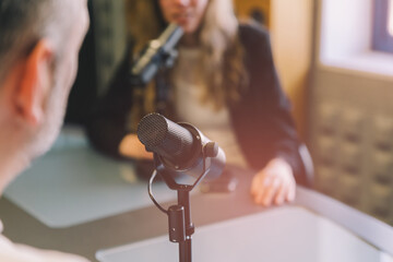 Close up of radio hosts recording podcast
