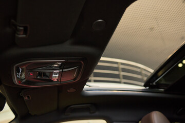 Motor vehicle with sunroof, rear view mirror, and hood