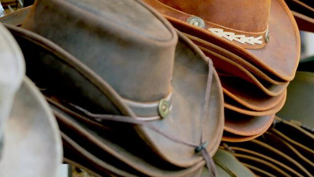 Closeup shot of the leather cowboy hats displaying for sale outside a retail shop in daytime