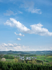 white houses in village near schmallenberg in spring and surrounding countryside