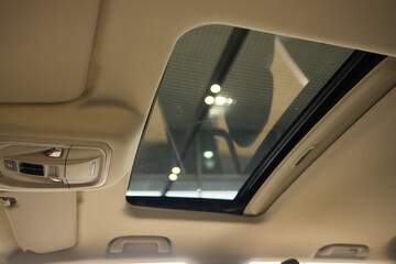 Motor vehicle with sunroof, rear view mirror, and hood