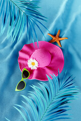 Summer accessories with palm leaf and starfish on blue towel background. Summer concept design. 3D Rendering, 3D Illustration