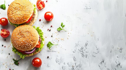 Two hamburgers with toppings on white rustic surface, surrounded by ingredients