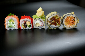 Sushi roll on a sleek black surface