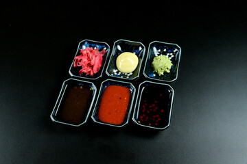 Table set with a tray and various small containers of sauces