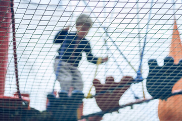A child playing is playing in a children's maze in the entertainment center. Hobbies and entertainment. Happy child, happy childhood. The concept of summer holidays. High quality photo