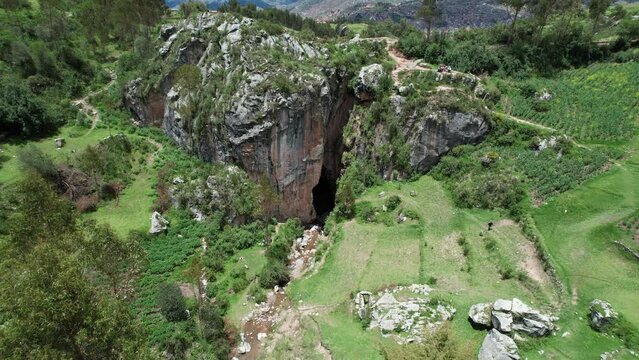 Aerial footage of the devils balcony Rock Formation with greenery in Cusco, Peru