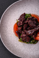 Delicious warm salad of chicken liver, spinach, arugula, tomatoes